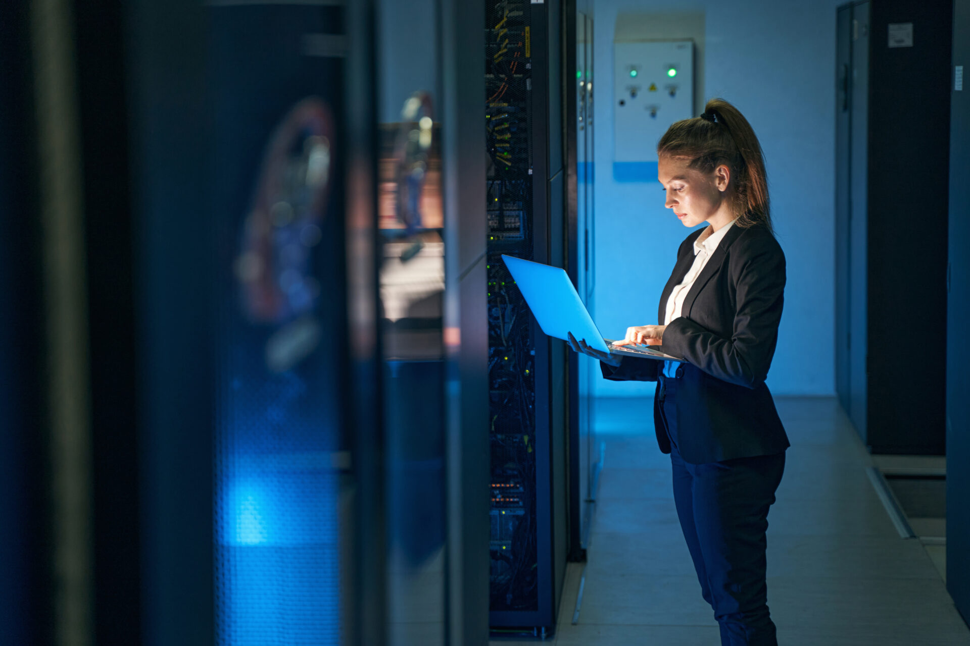 woman on a laptop in a server room for sovereign cloud